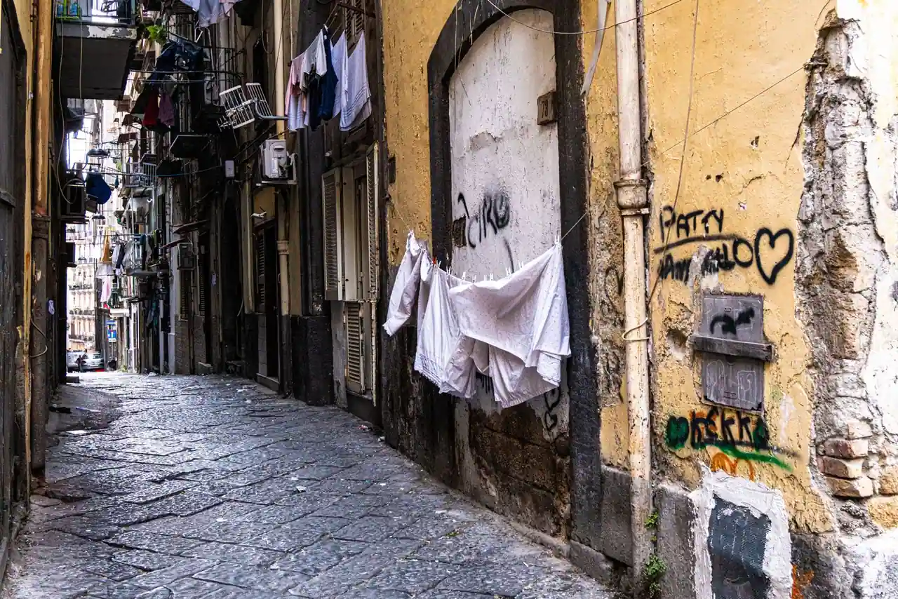 Ruelle pavée d'un vieux quartier du sud de l'Italie, linge étendu entre les façades